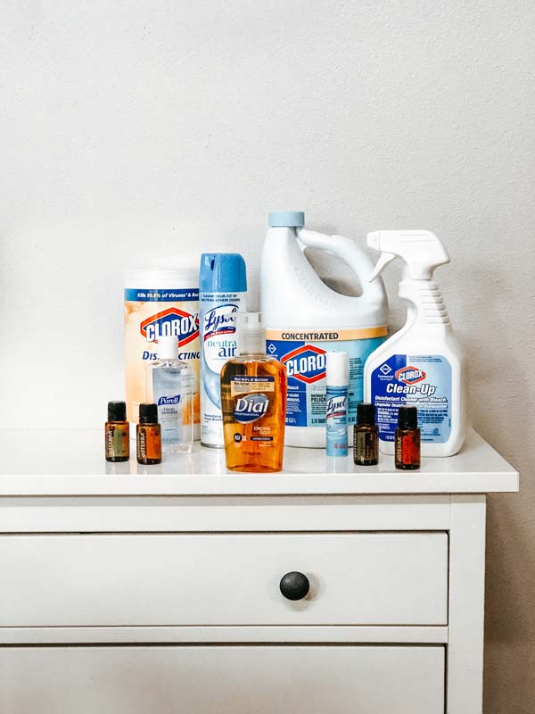 cleaning products on white dresser on white wall